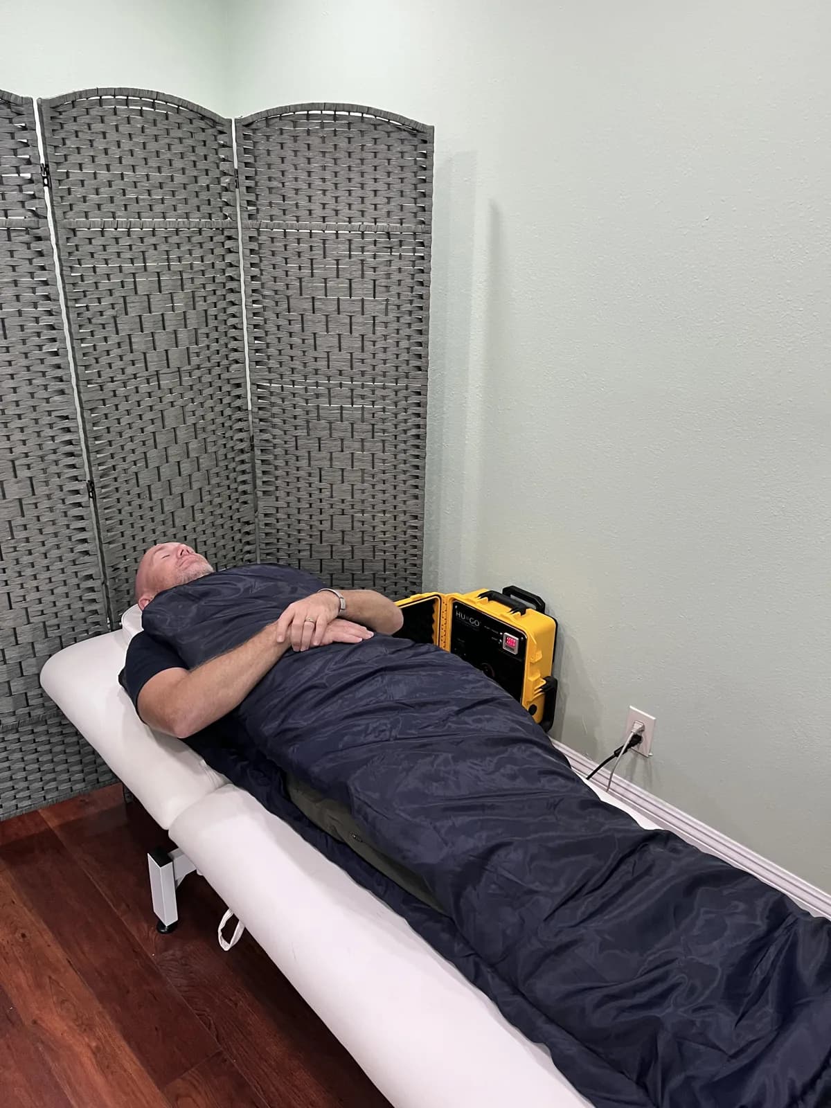 Chris demonstrating the HUGO PEMF mats at Trinity Naturopathic